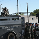 Police stand and watch Aug. 13, 2014, as demonstrators protest the Aug. 9 shooting death of teenager Michael Brown by a Ferguson, Mo., police officer.
Scott Olson/Getty Images